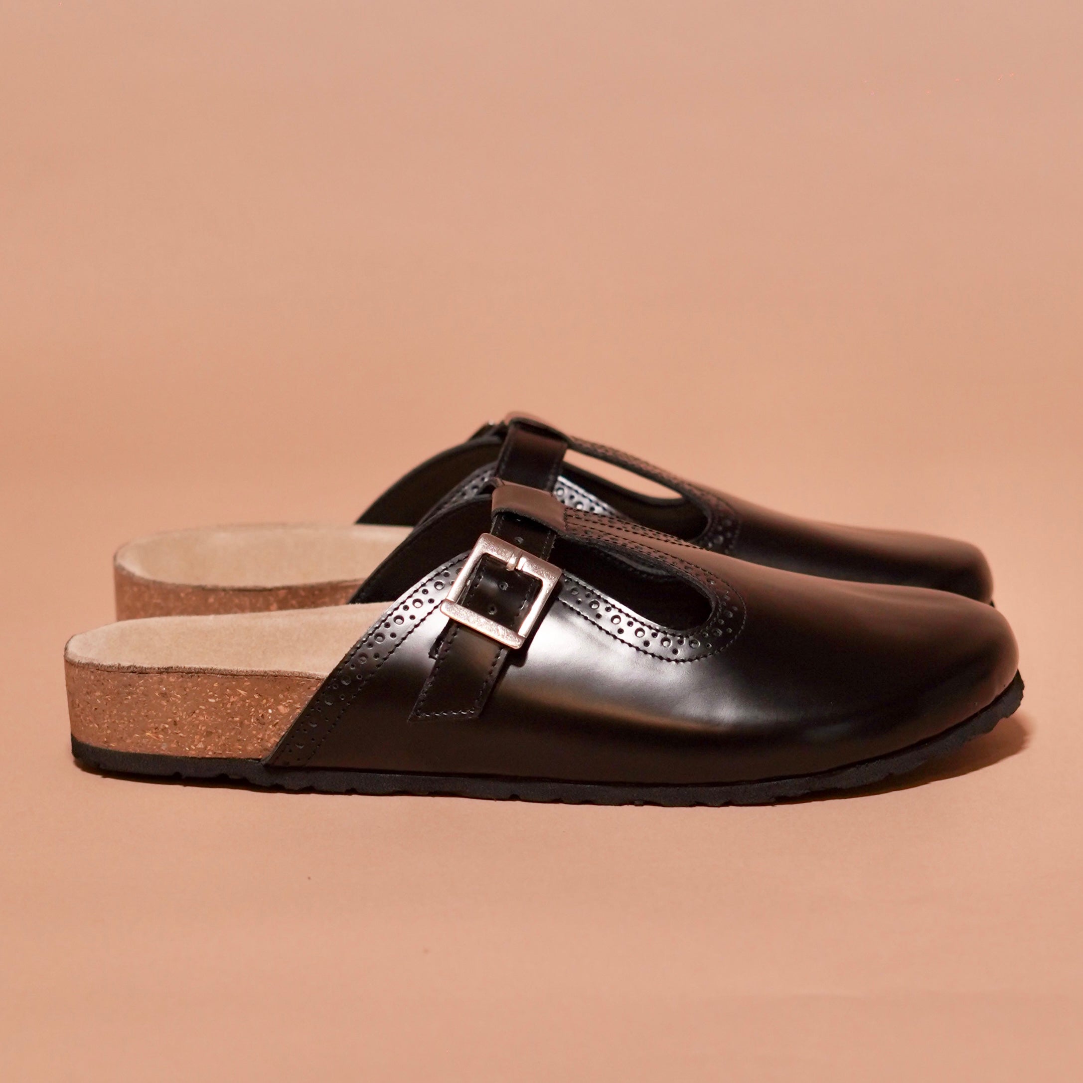 Side profile of Hoffler Corko Caro mule showing glossy leather and brogue details